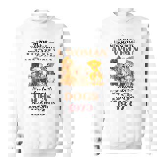 1973 A Woman Who Loves Dogs Sweatshirt | Mazezy