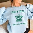 The Vibes Are In Shambles Sarcastic Raccoon Cowboy Women's Oversized Sweatshirt Light Blue